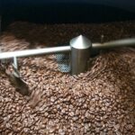 Air cooling roasted coffee beans